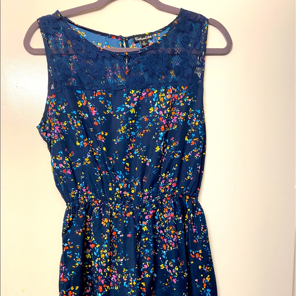 Navy blue romper with bright multicolor flowers.